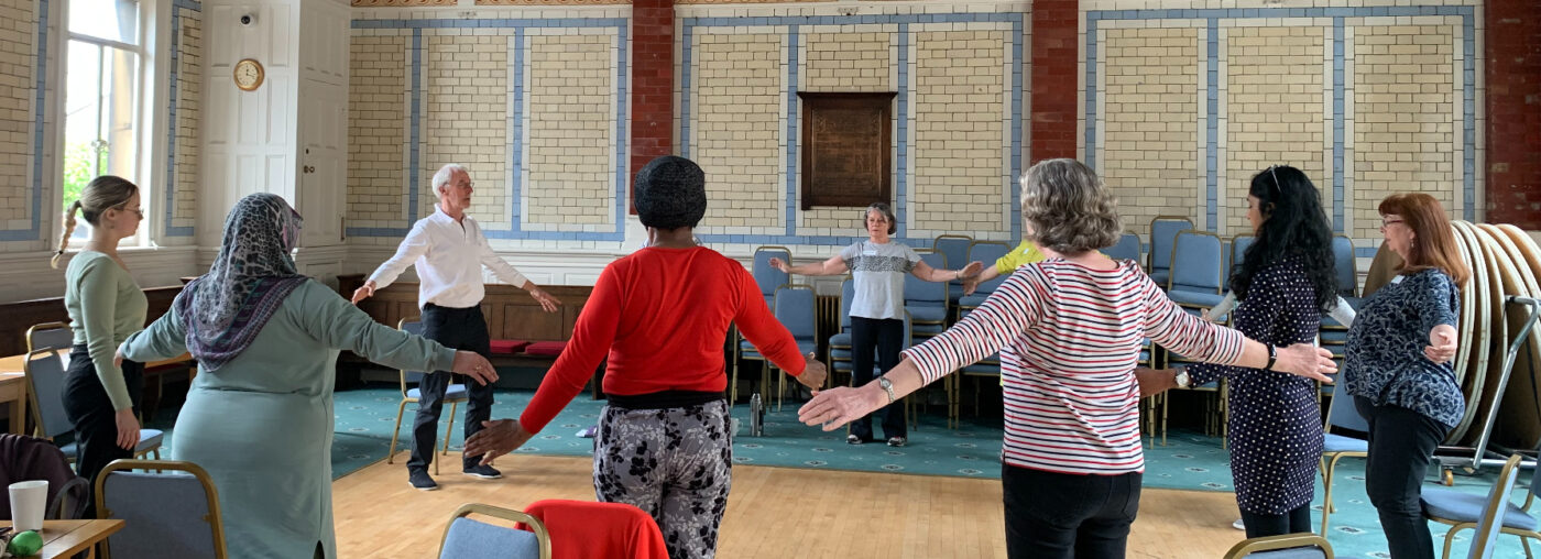A group of older people practising TaiChi