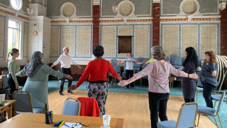 A group of older people practising TaiChi